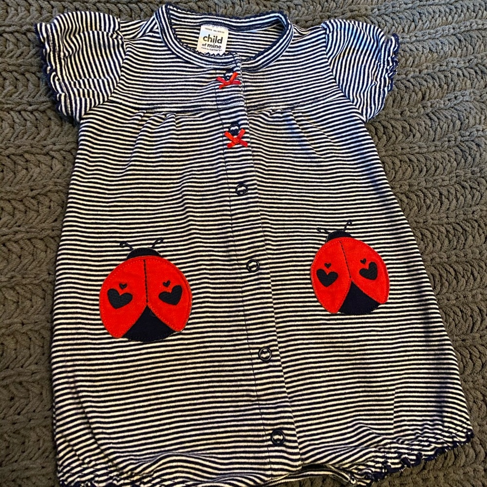 Navy and white striped romper with ladybugs.